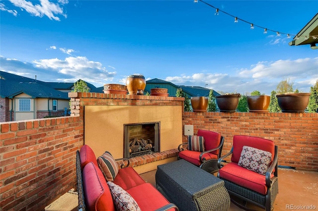 view of patio with an outdoor living space with a fireplace