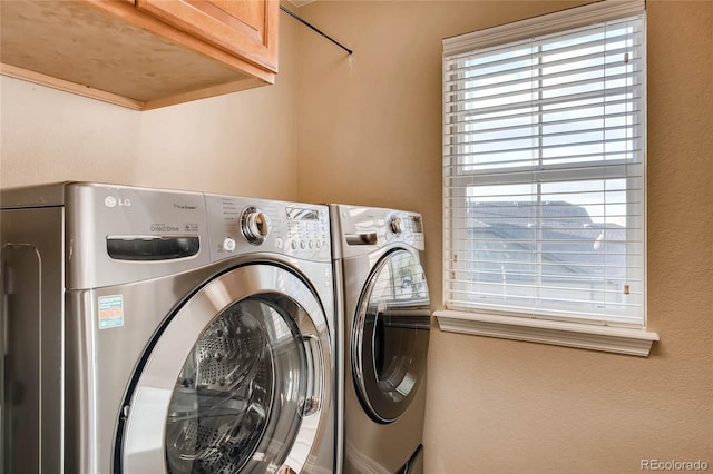 laundry room with washer and dryer and cabinet space