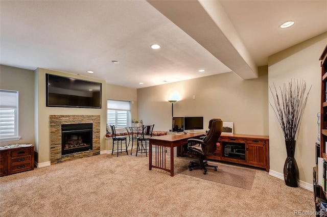 carpeted office space featuring recessed lighting, a fireplace, and baseboards