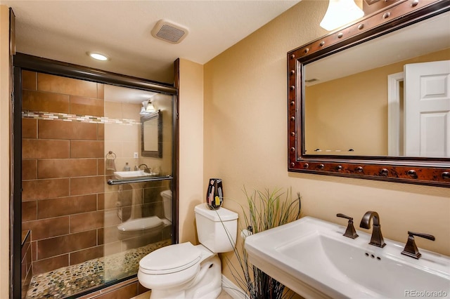 full bath featuring a sink, a stall shower, toilet, visible vents, and recessed lighting