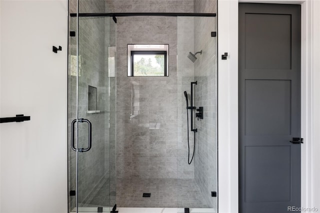 bathroom with a shower with door