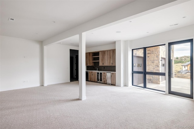 unfurnished living room featuring light carpet