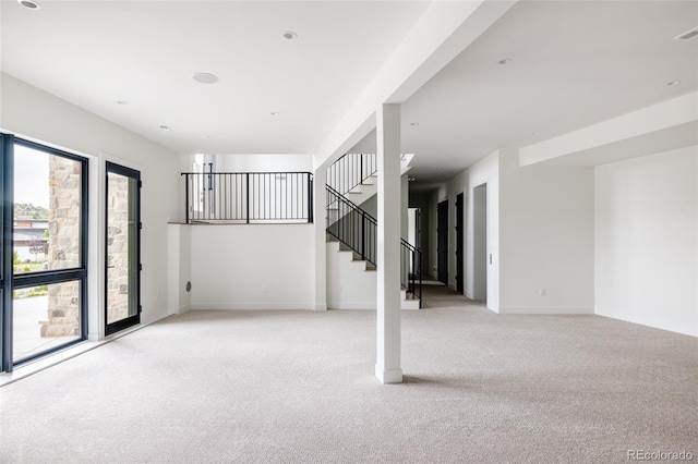 basement featuring light colored carpet