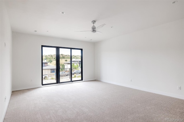 carpeted spare room with ceiling fan