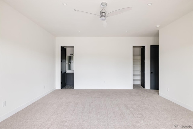 unfurnished room with ceiling fan and light carpet