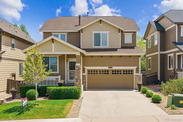 craftsman-style home featuring a garage, stone siding, concrete driveway, a porch, and fence