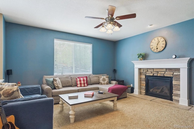 living area featuring a ceiling fan, a fireplace, and carpet