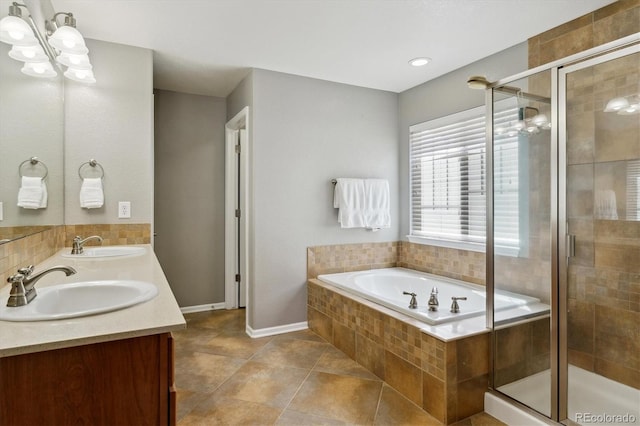 full bathroom featuring a chandelier, a shower stall, a bath, double vanity, and tile patterned flooring