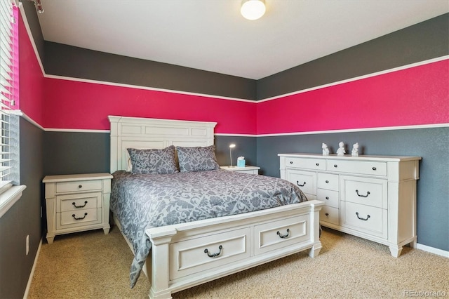 bedroom with light carpet and baseboards