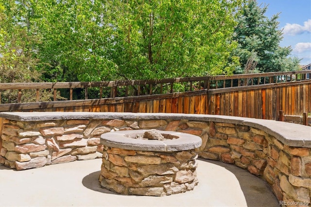 view of patio / terrace with fence and a fire pit