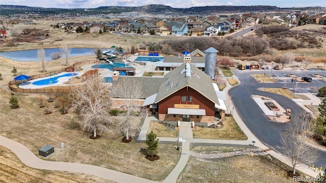 aerial perspective of suburban area with a nearby body of water