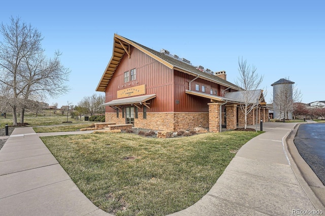 view of property exterior featuring stone siding and a lawn