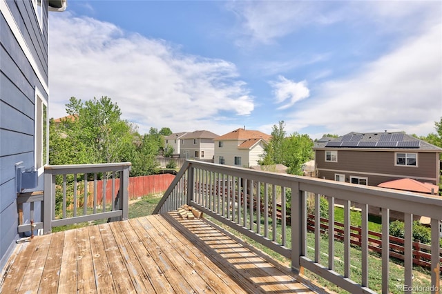 wooden terrace featuring a residential view and fence