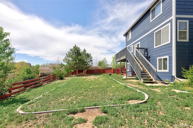 view of yard with stairway and a deck