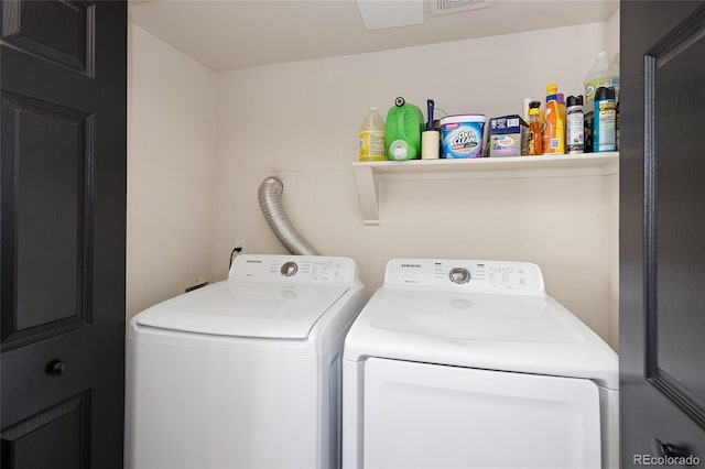 clothes washing area with washing machine and clothes dryer
