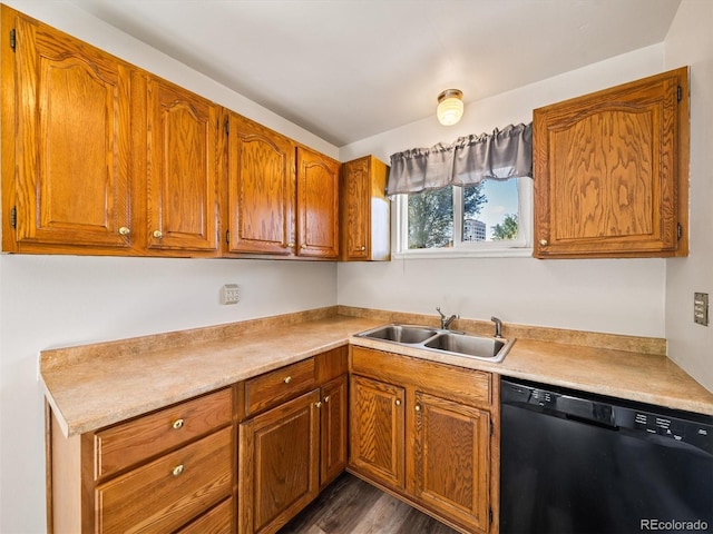kitchen with a sink, light countertops, black dishwasher, and brown cabinets