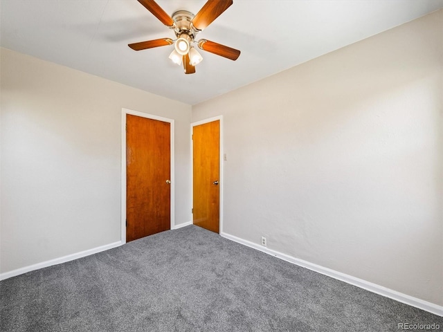 carpeted empty room with ceiling fan and baseboards