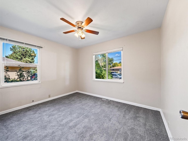 unfurnished room featuring a ceiling fan, carpet floors, baseboards, and visible vents