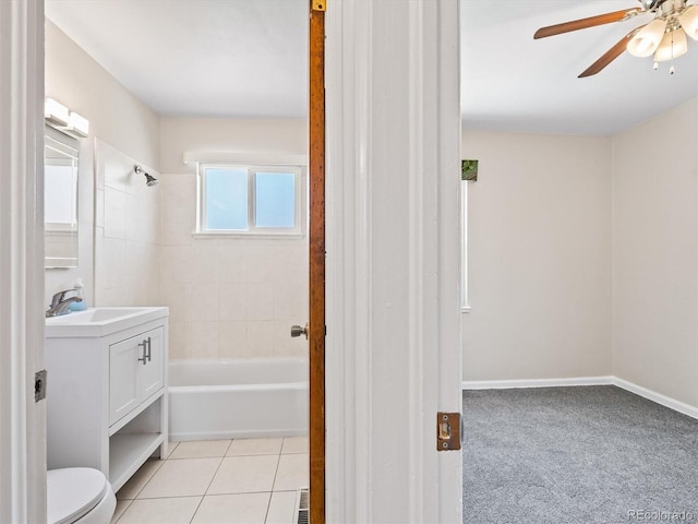 bathroom with toilet, ceiling fan, tile patterned floors, vanity, and shower / washtub combination