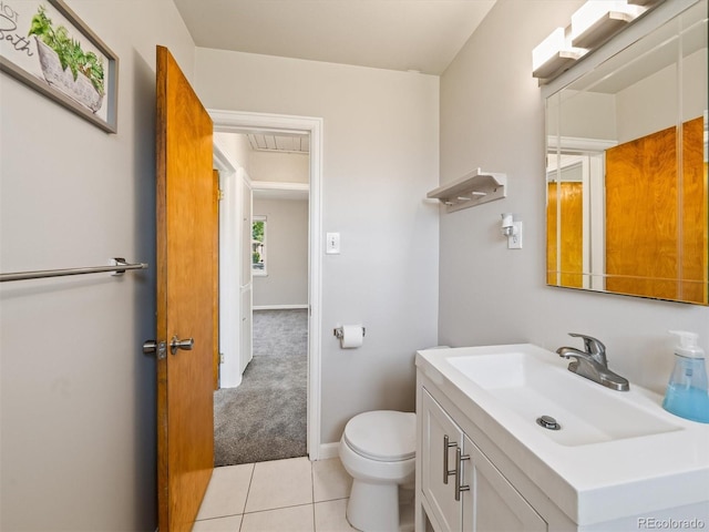 half bath with vanity, toilet, baseboards, and tile patterned floors