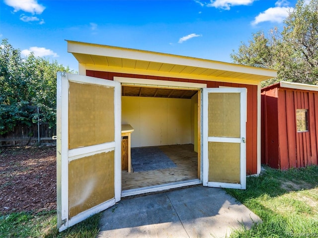 view of shed featuring fence