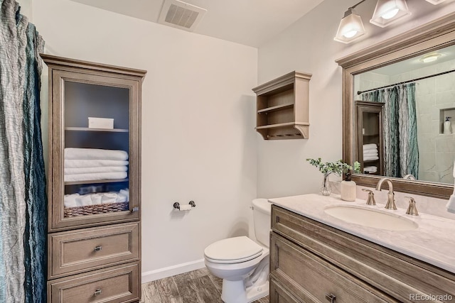 bathroom featuring a shower with curtain, vanity, toilet, and hardwood / wood-style floors