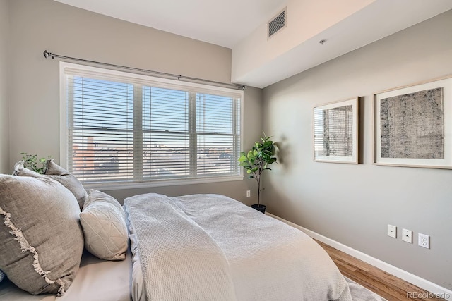 bedroom with hardwood / wood-style floors