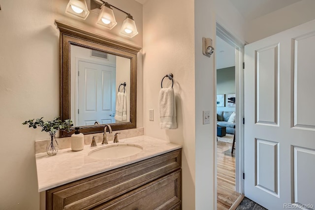 bathroom featuring hardwood / wood-style flooring and vanity