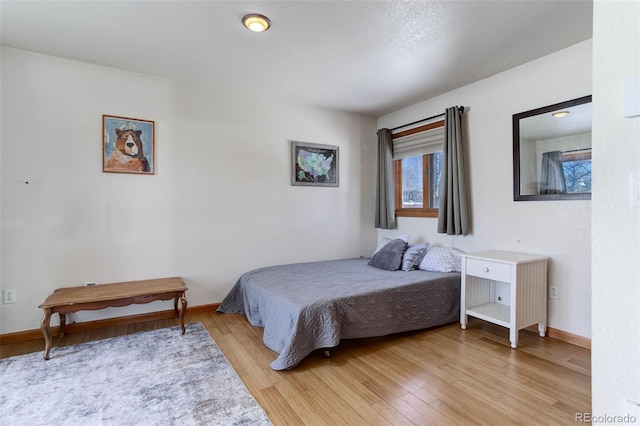 bedroom with light wood-type flooring