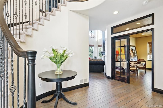 interior space with a chandelier and wood-type flooring