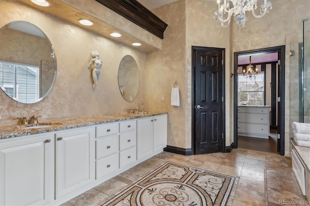 bathroom with vanity and an inviting chandelier