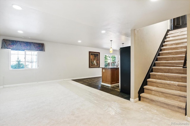 interior space with dark colored carpet