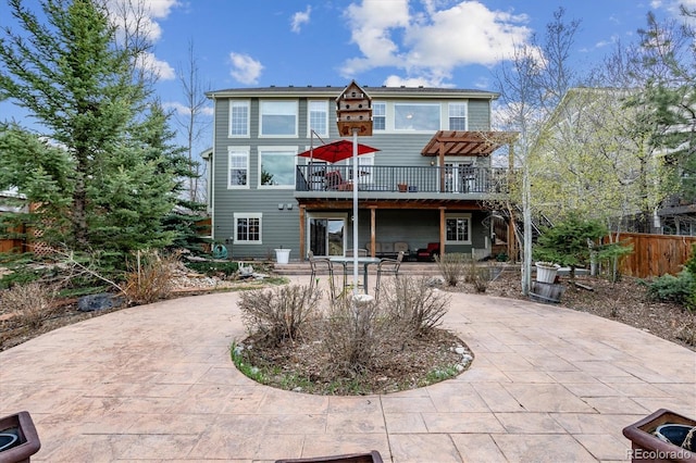 rear view of property featuring a patio and a deck