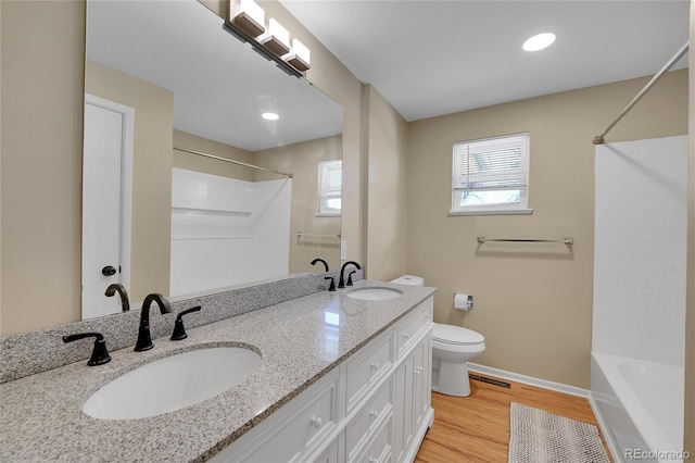 bathroom with vanity, wood-type flooring, and toilet