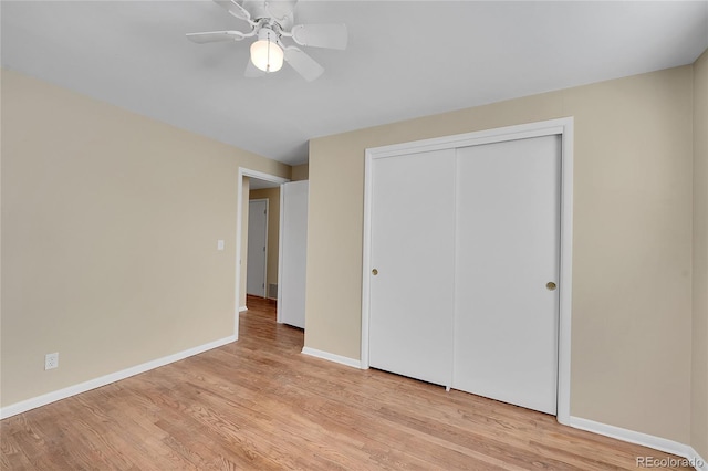 unfurnished bedroom with light hardwood / wood-style floors, ceiling fan, and a closet