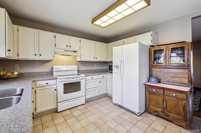 1479 S Jasper St, Aurora, CO 80017 - kitchen featuring white appliances, under cabinet range hood, light tile patterned floors, light countertops, and a sink