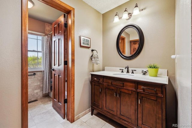 1479 S Jasper St, Aurora, CO 80017 - full bathroom with vanity, tile patterned floors, and baseboards