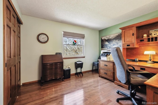 1479 S Jasper St, Aurora, CO 80017 - home office with light wood-style floors, a textured ceiling, and baseboards