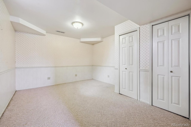 1479 S Jasper St, Aurora, CO 80017 - unfurnished bedroom with wallpapered walls, carpet floors, and wainscoting