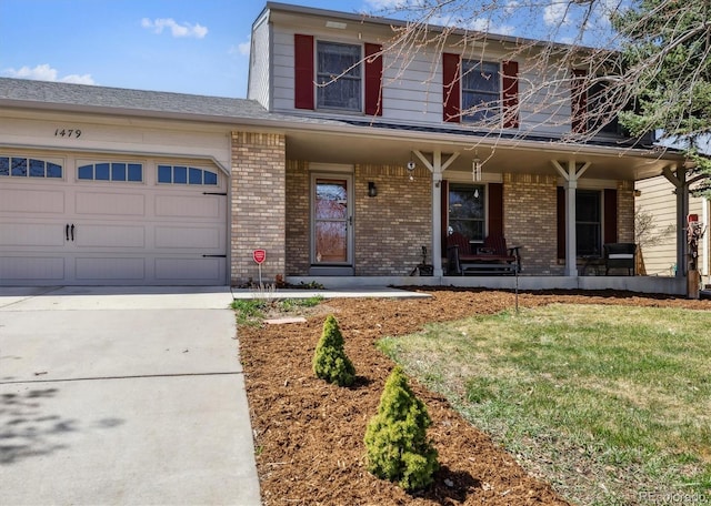 1479 S Jasper St, Aurora, CO 80017 - traditional home with brick siding, concrete driveway, a porch, a garage, and a front lawn