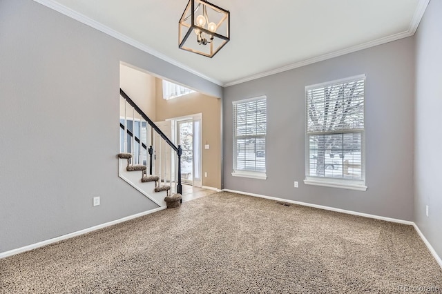 carpeted entryway with crown molding and an inviting chandelier