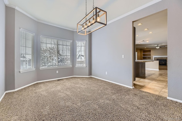 empty room with ceiling fan with notable chandelier, carpet floors, and ornamental molding