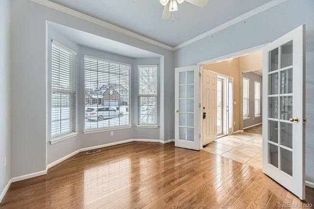 unfurnished room featuring french doors and a healthy amount of sunlight