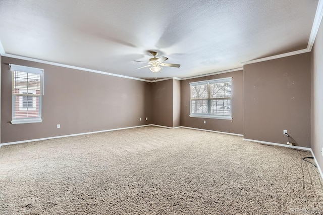 carpeted empty room with ceiling fan and ornamental molding