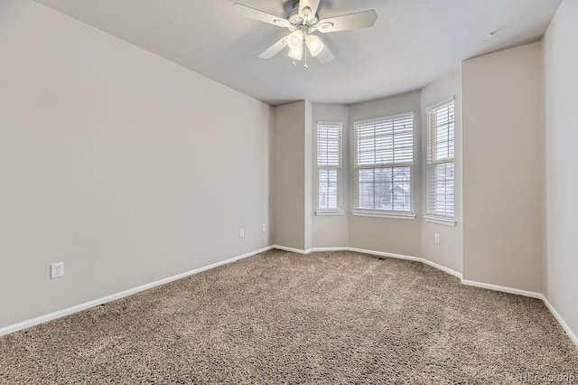 unfurnished room featuring ceiling fan and carpet floors