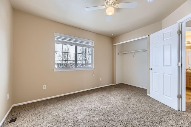 unfurnished bedroom with carpet floors, a closet, and ceiling fan