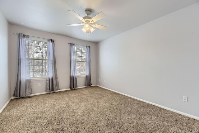 carpeted spare room featuring ceiling fan