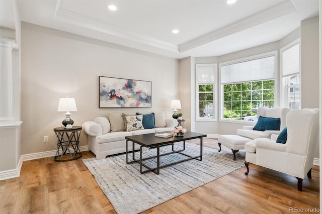 11911 E Lake Cir, Greenwood Village, CO 80111 - living room featuring decorative columns, a raised ceiling, wood finished floors, crown molding, and recessed lighting