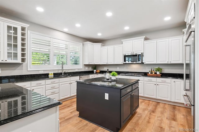 11911 E Lake Cir, Greenwood Village, CO 80111 - kitchen featuring appliances with stainless steel finishes, white cabinets, recessed lighting, a center island, and light wood-style floors