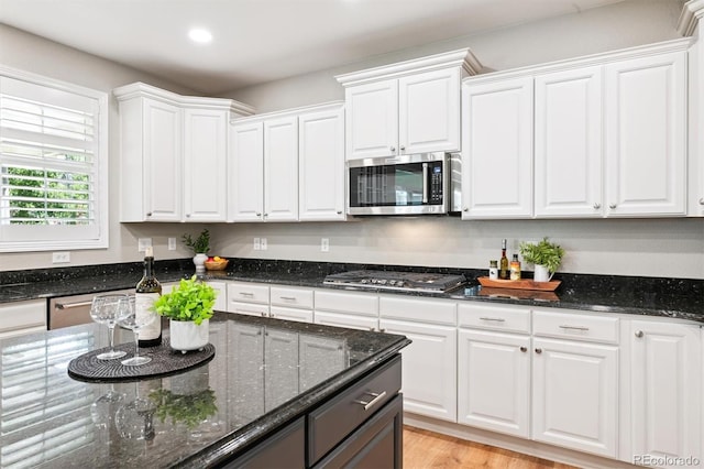 11911 E Lake Cir, Greenwood Village, CO 80111 - kitchen featuring appliances with stainless steel finishes, white cabinets, dark stone counters, recessed lighting, and light wood finished floors